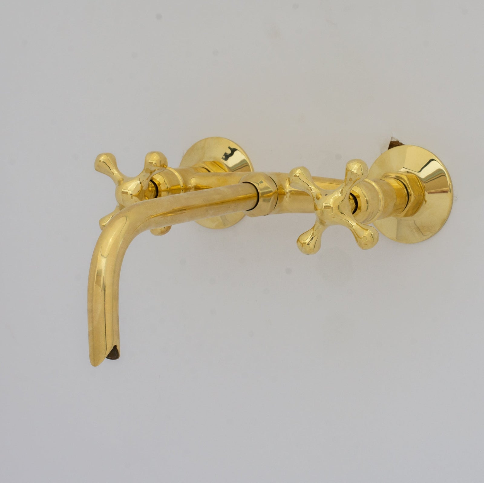 Gold faucet on a gray background