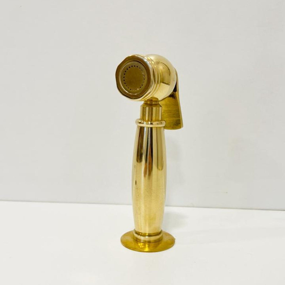 Brass bathroom faucet handle on a white background