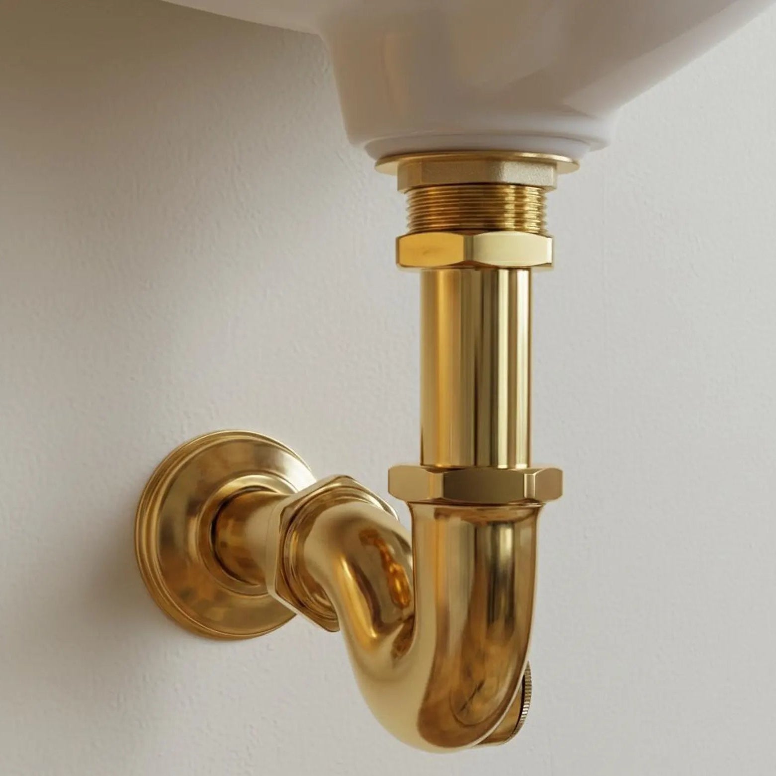 Close-up of a gold plumbing fixture on a white background
