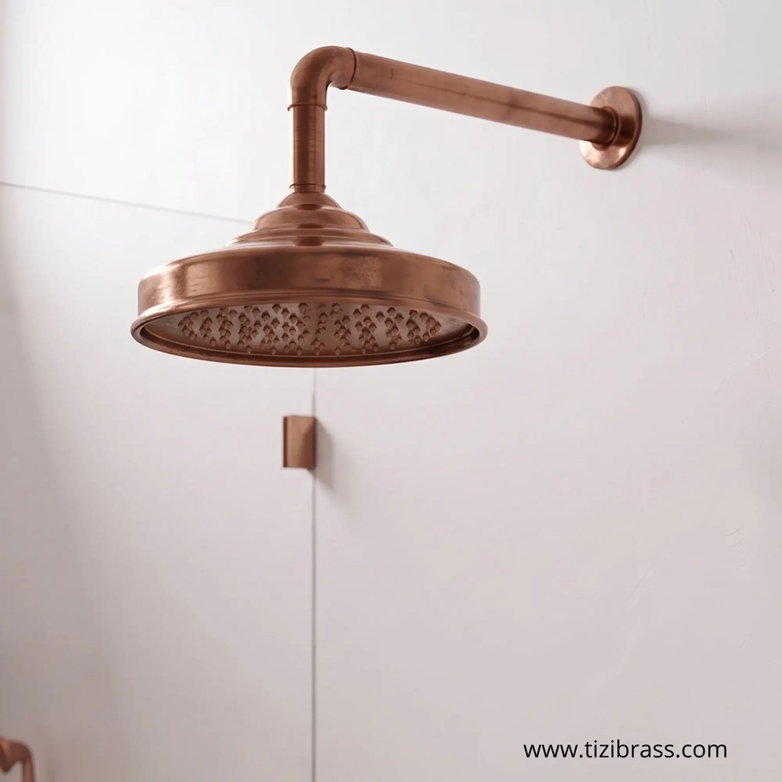 Wall-mounted copper rain shower head with exposed pipe design.