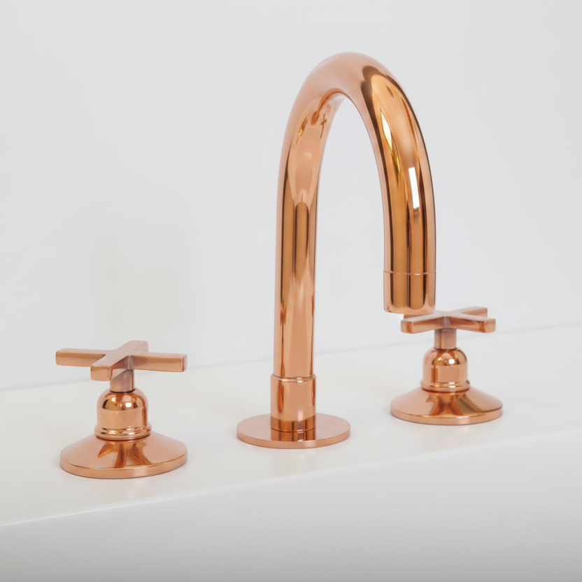 A modern three-hole faucet set with a tall arched spout and two cross-shaped handles, all in a polished copper finish against a clean white background.