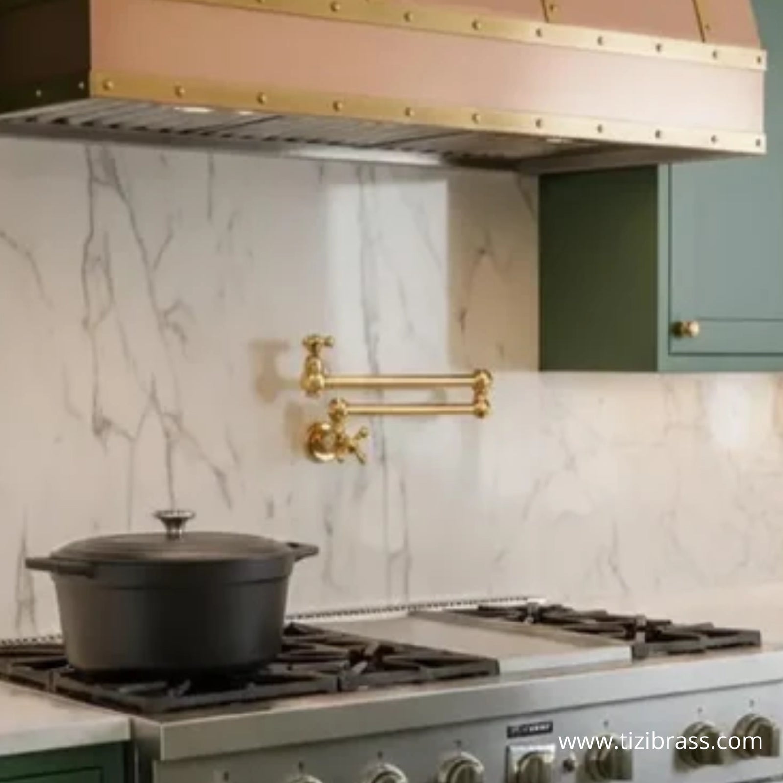 Unlacquered brass pot filler faucet mounted on marble backsplash above a gas range – TiziBrass